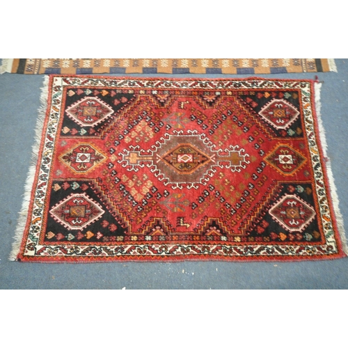 1605 - A RED GROUNG PERSIAN SHIRAZ RUG, length 136cm x depth 92cm, and another rug (good condition) (2)