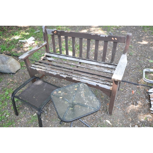 1206 - A BROWN PAINTED WOODEN SLATTED GARDEN BENCH, width 128cm x depth 57cm together with a mesh footstool... 