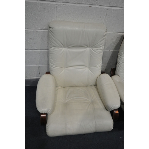 1151 - A NEAR PAIR OF BUTTONED CREAM LEATHERETTE SWIVEL ARMCHAIRS, on stained beech frame and stand, width ... 