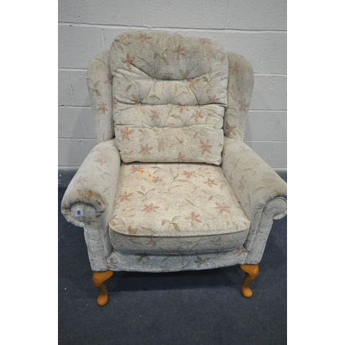 1167 - A FLORAL UPHOLSTERED WING BACK ARMCHAIR