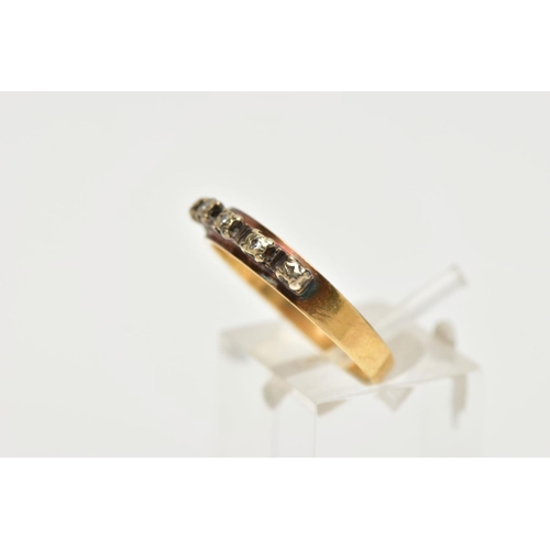 120A - A YELLOW METAL DIAMOND HALF ETERNITY RING, the three illusion set diamonds to the metal capped sides... 