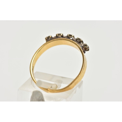 120A - A YELLOW METAL DIAMOND HALF ETERNITY RING, the three illusion set diamonds to the metal capped sides... 