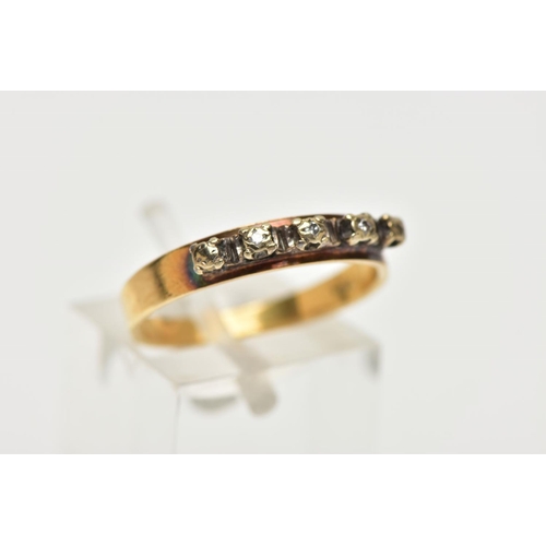 120A - A YELLOW METAL DIAMOND HALF ETERNITY RING, the three illusion set diamonds to the metal capped sides... 