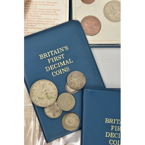 123 - A CARDBOARD BOX AND TIN OF COINS, to include 9x Britain's first decimal walleted coins, a tin of mix... 