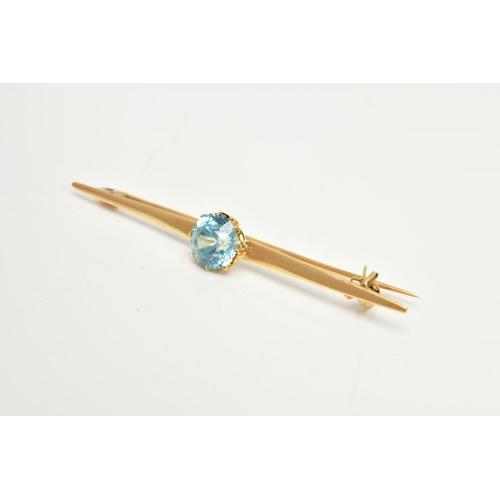 126 - A YELLOW METAL ZIRCON BAR BROOCH, set with a circular blue zircon, measuring approximately 8.5 x 8.4... 