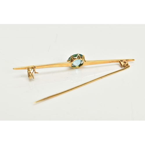 126 - A YELLOW METAL ZIRCON BAR BROOCH, set with a circular blue zircon, measuring approximately 8.5 x 8.4... 