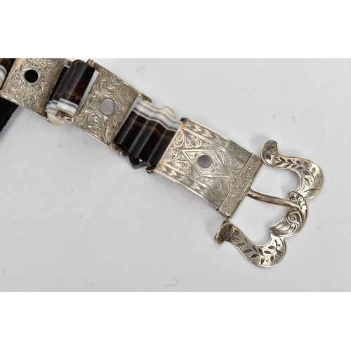 131 - A LATE VICTORIAN BANDED AGATE BUCKLE BRACELET, designed as a series of scroll engraved links, inters... 