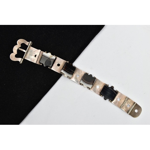 131 - A LATE VICTORIAN BANDED AGATE BUCKLE BRACELET, designed as a series of scroll engraved links, inters... 