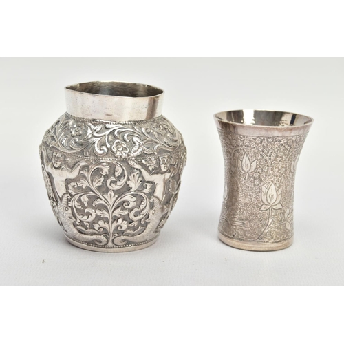 138 - TWO WHITE METAL VASES, both of Indian design, the first decorated with raised foliate scenes, approx... 