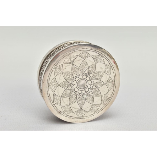 140 - AN INDIAN WHITE METAL BOX, the circular box with scroll and floral embossed detail and fitted lid, a... 