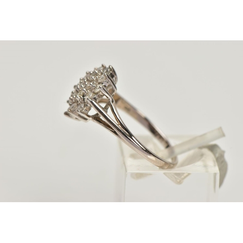 152 - A 9CT WHITE GOLD BRILLIANT-CUT DIAMOND CLUSTER RING, with nineteen graduated diamonds to the trifurc... 