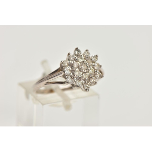 152 - A 9CT WHITE GOLD BRILLIANT-CUT DIAMOND CLUSTER RING, with nineteen graduated diamonds to the trifurc... 