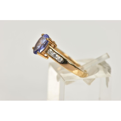 167 - A 9CT GOLD TANZANITE AND COLOURLESS GEM DRESS RING, the oval tanzanite, to the circular colourless g... 