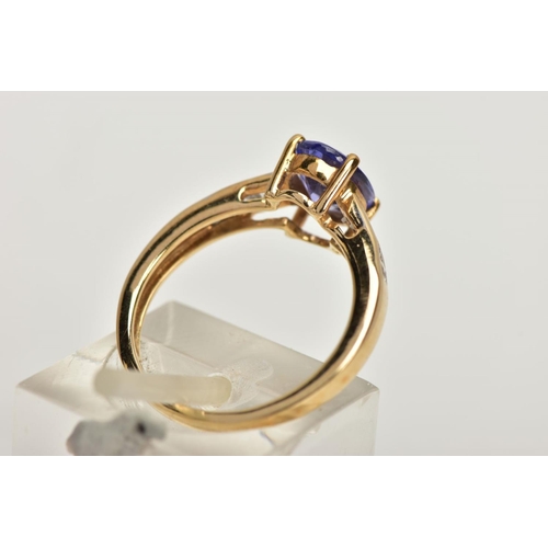 167 - A 9CT GOLD TANZANITE AND COLOURLESS GEM DRESS RING, the oval tanzanite, to the circular colourless g... 