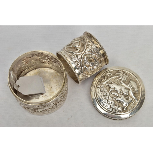 179 - TWO EARLY 20TH CENTURY ITEMS, the first an embossed unmarked white metal pot depicting a hunting sce... 