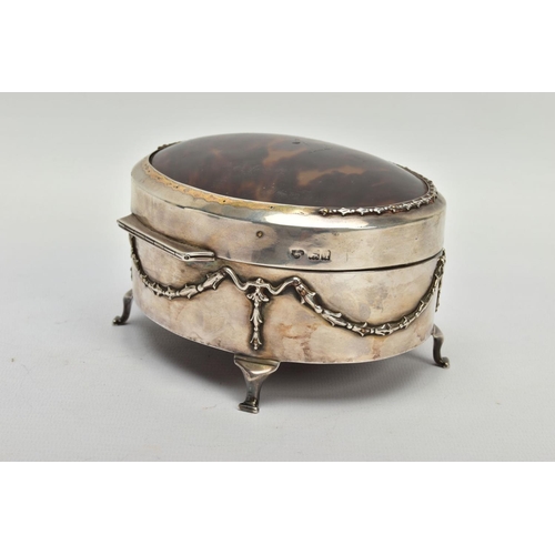 183 - AN EARLY 20TH CENTURY SILVER AND TORTOISESHELL HINGED BOX, the oval trinket box with embossed garlan... 