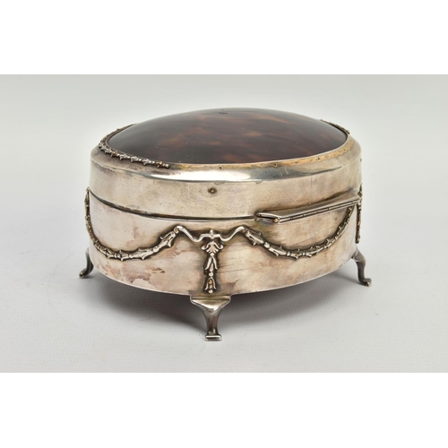 183 - AN EARLY 20TH CENTURY SILVER AND TORTOISESHELL HINGED BOX, the oval trinket box with embossed garlan... 