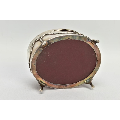 183 - AN EARLY 20TH CENTURY SILVER AND TORTOISESHELL HINGED BOX, the oval trinket box with embossed garlan... 