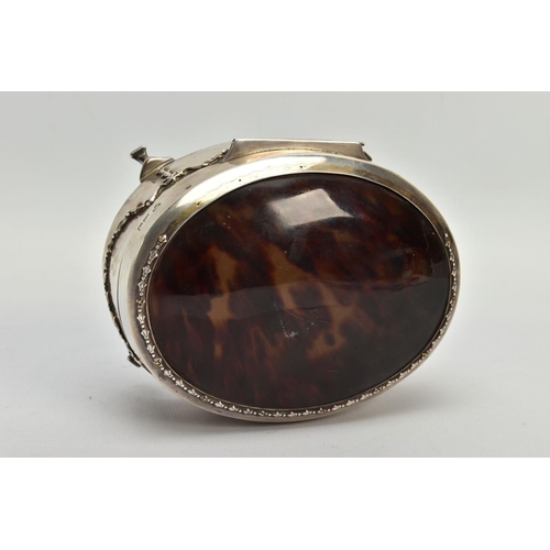 183 - AN EARLY 20TH CENTURY SILVER AND TORTOISESHELL HINGED BOX, the oval trinket box with embossed garlan... 