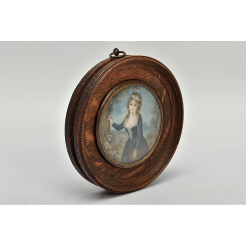 184 - A WOODEN PORTRAIT MINIATURE, depicting a Georgian lady within a garden painting onto a tree, with gl... 