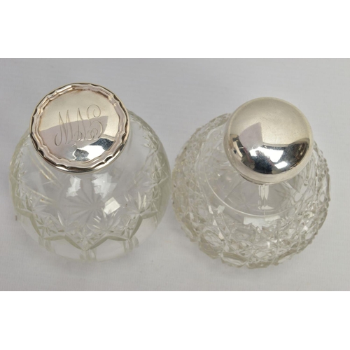 186 - TWO GLASS SILVER TOPPED PRESSED BOTTLES, each designed as a rounded glass bottle with silver tops an... 