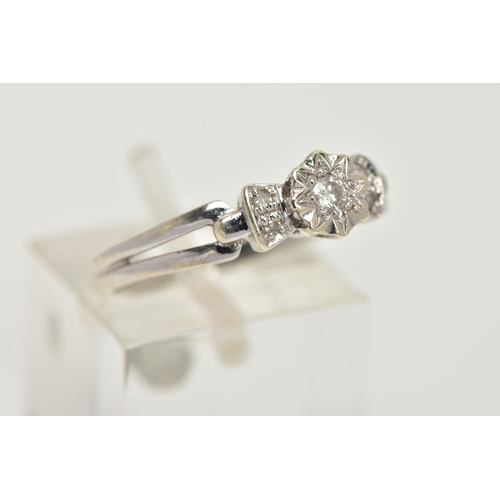 20 - A 9CT WHITE GOLD DIAMOND RING, centring on an illusion set round brilliant cut diamond, flanked with... 