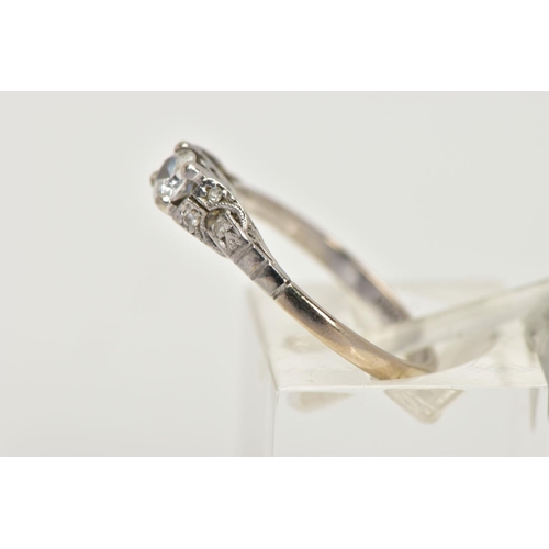 22 - A WHITE METAL DIAMOND RING, centring on a four claw set, round brilliant cut diamond, estimated diam... 