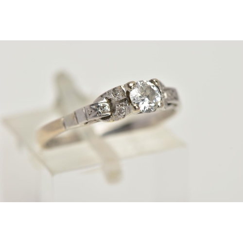22 - A WHITE METAL DIAMOND RING, centring on a four claw set, round brilliant cut diamond, estimated diam... 