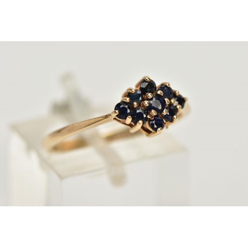 24 - A 9CT GOLD SAPPHIRE CLUSTER RING, tiered cluster of a navette shape, set with nine circular cut deep... 