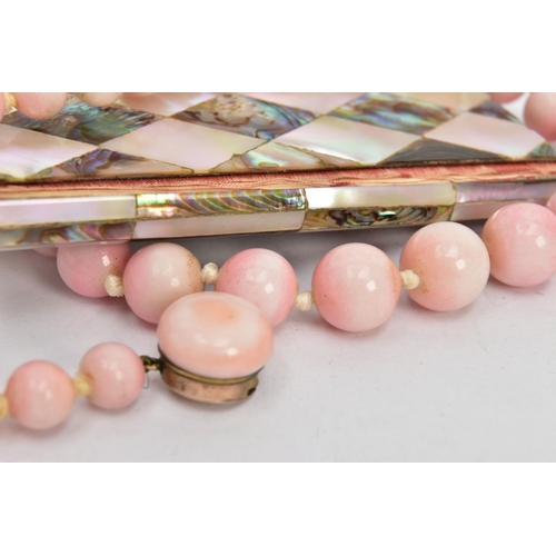 32 - A CERAMIC BEAD NECKLACE AND AN AIDE MEMOIRE, a graduated pink glazed ceramic bead necklace, fitted w... 