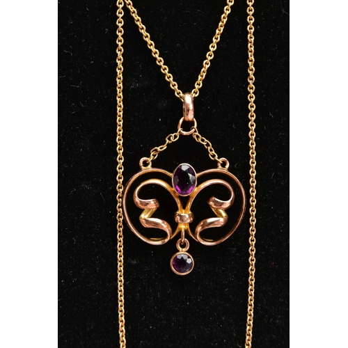 43 - A YELLOW METAL LAVALIER PENDANT NECKLACE, openwork scroll pendant set with an oval cut amethyst in a... 