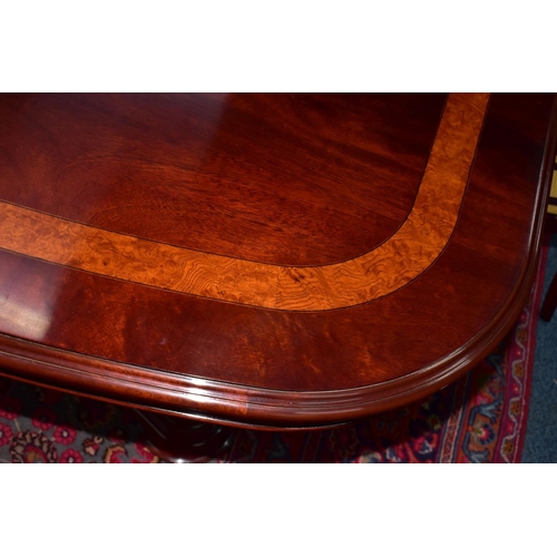 445A - A CHARLES BARR MAHOGANY AND BURR WOOD INLAID EXTENDING PEDESTAL DINING TABLE, with one additional le... 