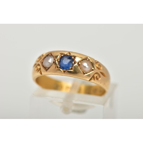 55 - A LATE VICTORIAN 18CT GOLD RING, centring on a star set, cushion cut blue sapphire, flanked with spl... 