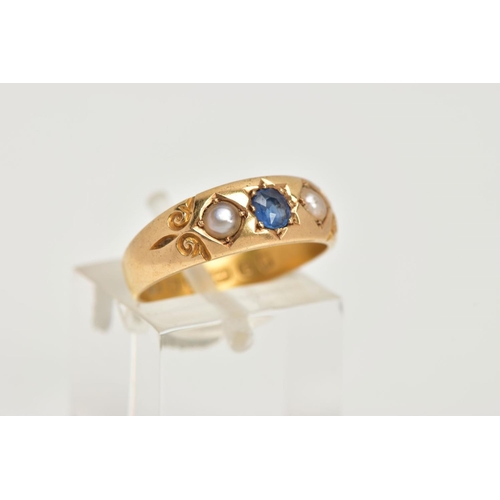 55 - A LATE VICTORIAN 18CT GOLD RING, centring on a star set, cushion cut blue sapphire, flanked with spl... 