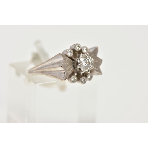 56 - A WHITE METAL DIAMOND RING, abstract bow style ring set centrally with a round brilliant cut diamond... 