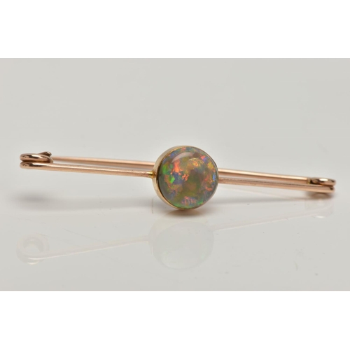 62 - AN OPAL BAR BROOCH, a circular cut opal cabochon, extensive colour play showing flashes of green, bl... 