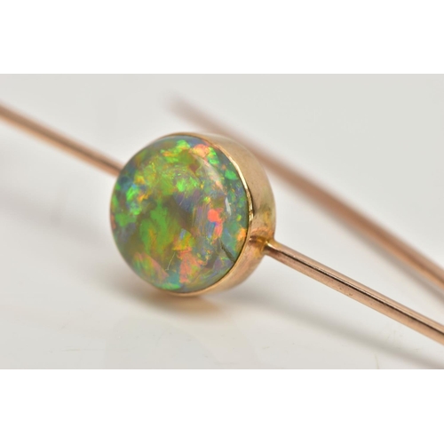 62 - AN OPAL BAR BROOCH, a circular cut opal cabochon, extensive colour play showing flashes of green, bl... 