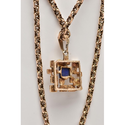 63 - A 9CT GOLD LAPIS LAZULI AND CULTURED PEARL ABSTRACT PENDANT WITH CHAIN, the textured and polished ab... 