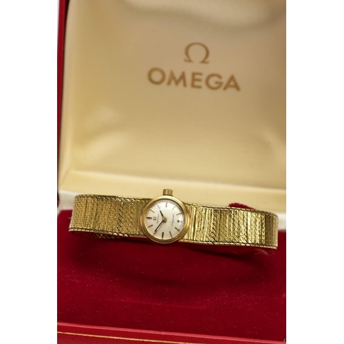 67 - A LADIES 9CT GOLD 'OMEGA' WRISTWATCH, a hand wound movement, round silver tone dial signed 'Omega La... 