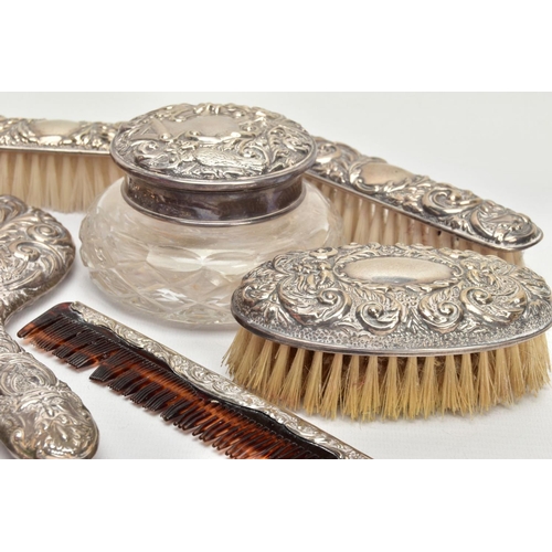 90 - A SILVER VANITY SET, comprising nine items to include a mirror, a molded glass powder bottle, a hair... 