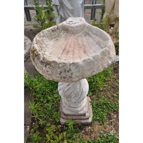 1205 - A COMPOSITE SHELL SHAPED BIRD BATH, on a separate spiralling base, height 76cm (condition:-missing b... 