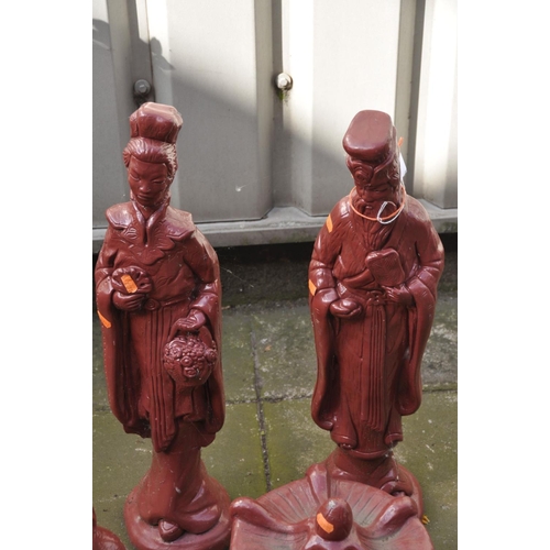 1225 - FOUR RED FINISH COMPOSITE JAPANESE FIGURES, to include a male and female standing figure (loose head... 