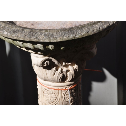 1230 - A COMPOSITE BIRD BATH, on a pattered Corinthian column support with religious figures to bottom half... 