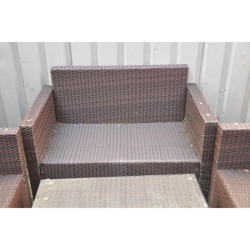 1235 - A RATTAN EFFECT GARDEN SET, comprising a two seater bench, pair of armchairs and a coffee table with... 