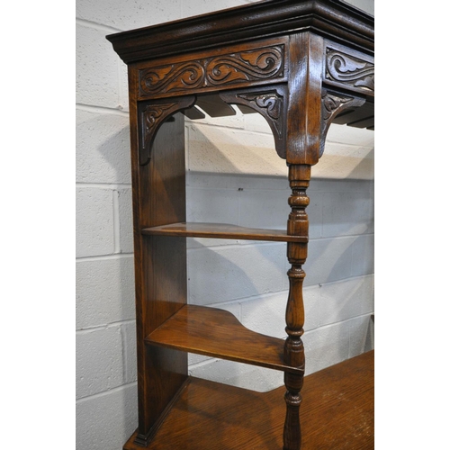 1412 - A MID 20TH CENTURY OAK LINENFOLD BAR, the top with wine glass holders, four shelves with turned supp... 