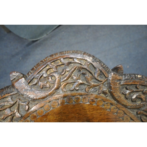 1413 - A 19TH CENTURY ANGLO INDIAN HEAVILY CARVED PADOUK OCCASIONAL TABLE, the top with foliate detail surr... 