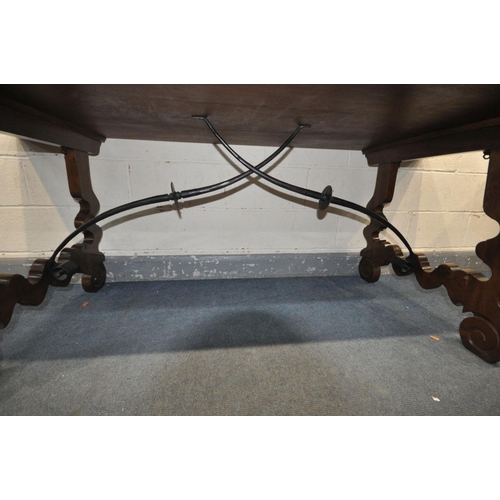 1423 - A 20TH CENTURY SPANISH WALNUT REFECTORY TABLE, on a pair of shaped trestle legs, united by a pair of... 