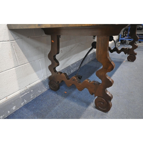 1423 - A 20TH CENTURY SPANISH WALNUT REFECTORY TABLE, on a pair of shaped trestle legs, united by a pair of... 