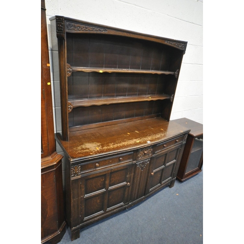 1432 - A 20TH CENTURY OAK DRESSER, the top with two tier plate rack, the base with three drawers and two cu... 