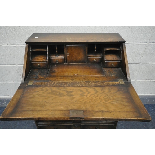 1459 - AN OAK BUREAU, with a fitted interior, and three exterior drawers, width 77cm x depth 47cm x height ... 